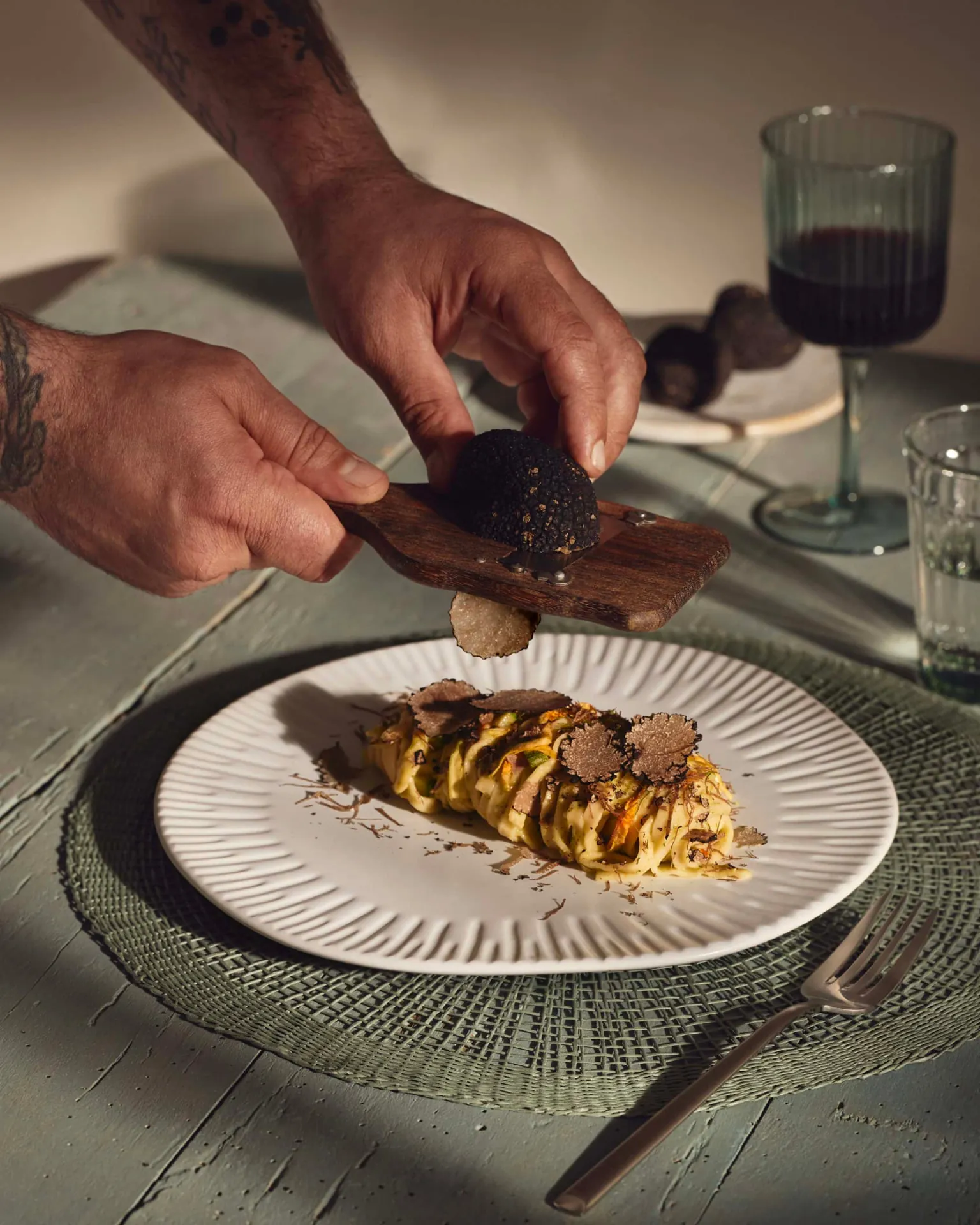 Fresh truffle shaved over pasta at the table